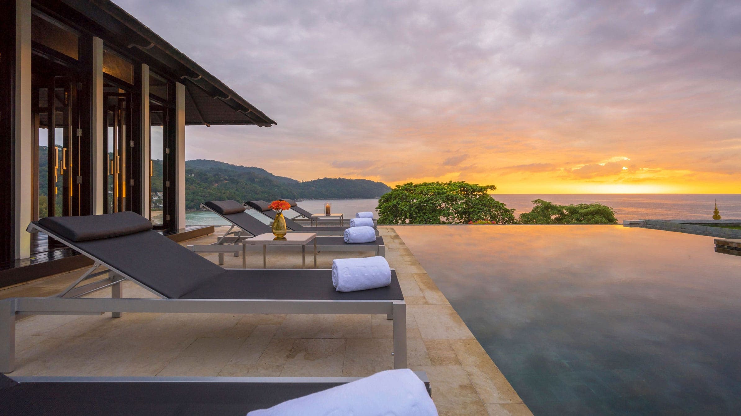 Sunset by the infinity pool with sun loungers